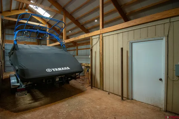 a room with water heater and wooden walls