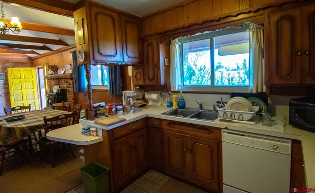 a kitchen with a sink cabinets a window and appliances