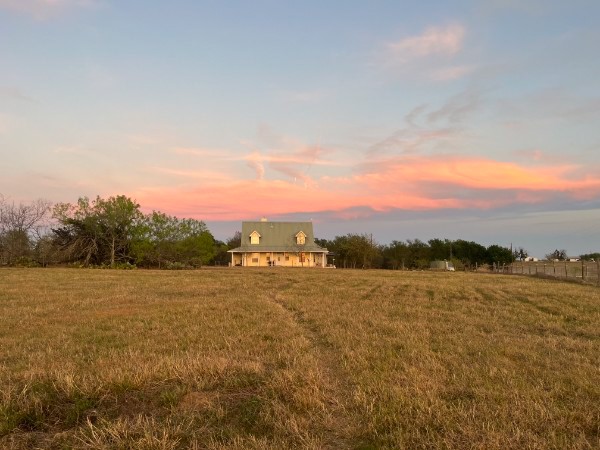 928 Upper Elgin River Road Elgin, TX 78621 - Photo 37 of 40 Spacious property featuring a traditional-style home with a dormer roof, a covered porch, and light-colored siding.