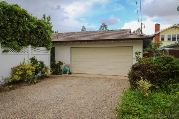 a view of a house with a small yard and plants