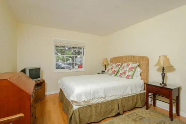 a bedroom with a bed and a table