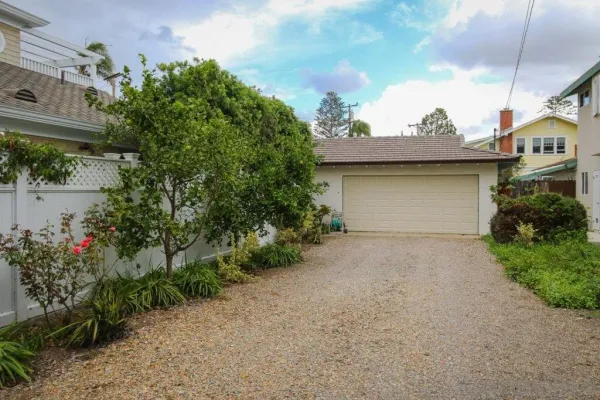a front view of a house with a garden