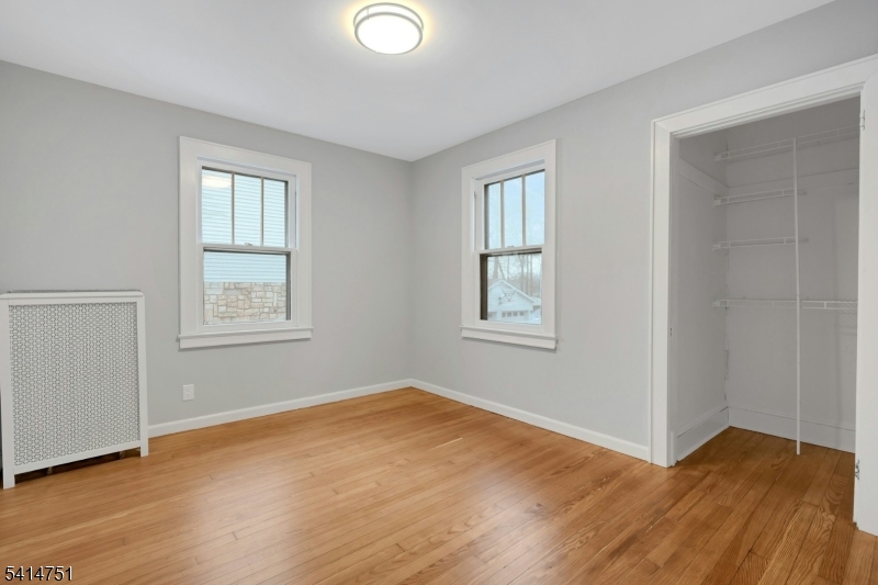 173 Runnymede Road West Caldwell, NJ 07006 - Photo 17 of 27 a view of an empty room with wooden floor and a window