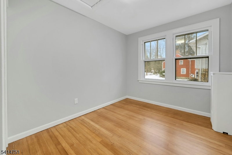 173 Runnymede Road West Caldwell, NJ 07006 - Photo 18 of 27 a view of an empty room with wooden floor and a window
