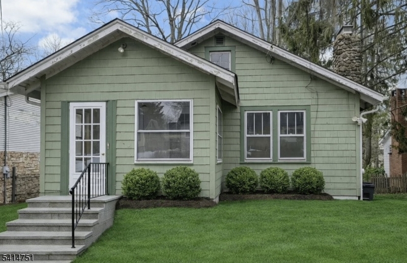 173 Runnymede Road West Caldwell, NJ 07006 - Photo 2 of 27 a front view of a house with a garden