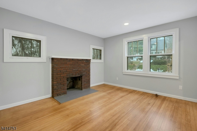 173 Runnymede Road West Caldwell, NJ 07006 - Photo 26 of 27 a view of empty room with wooden floor and fireplace