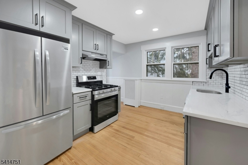 173 Runnymede Road West Caldwell, NJ 07006 - Photo 4 of 27 a kitchen with granite countertop a refrigerator stove and sink