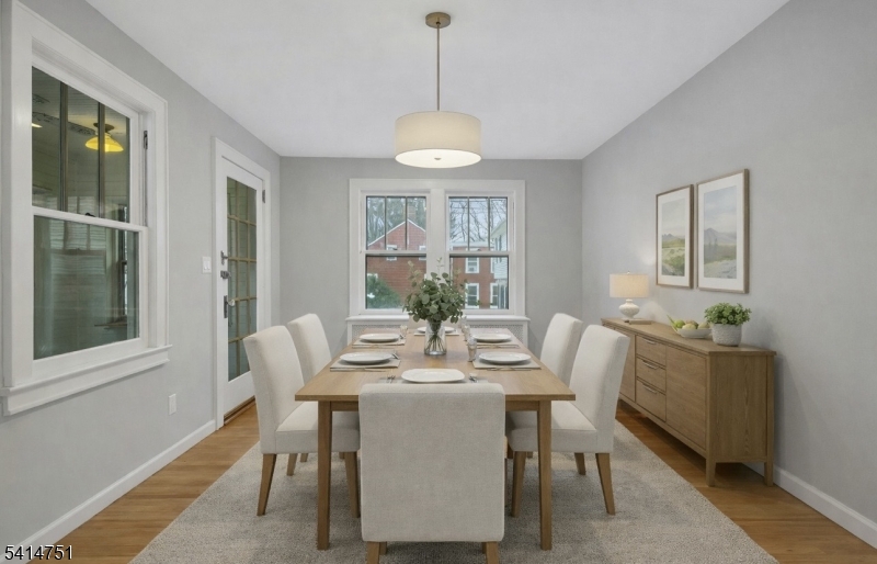 173 Runnymede Road West Caldwell, NJ 07006 - Photo 5 of 27 a dining room with furniture a chandelier and wooden floor