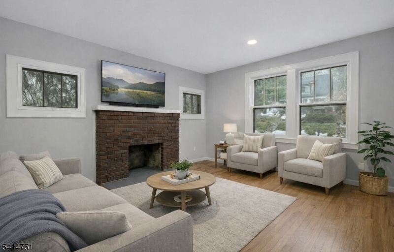 173 Runnymede Road West Caldwell, NJ 07006 - Photo 6 of 27 a living room with furniture and a fireplace