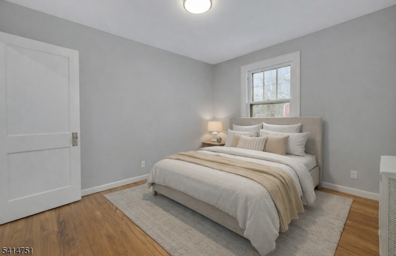 173 Runnymede Road West Caldwell, NJ 07006 - Photo 8 of 27 a bedroom with a bed and a window