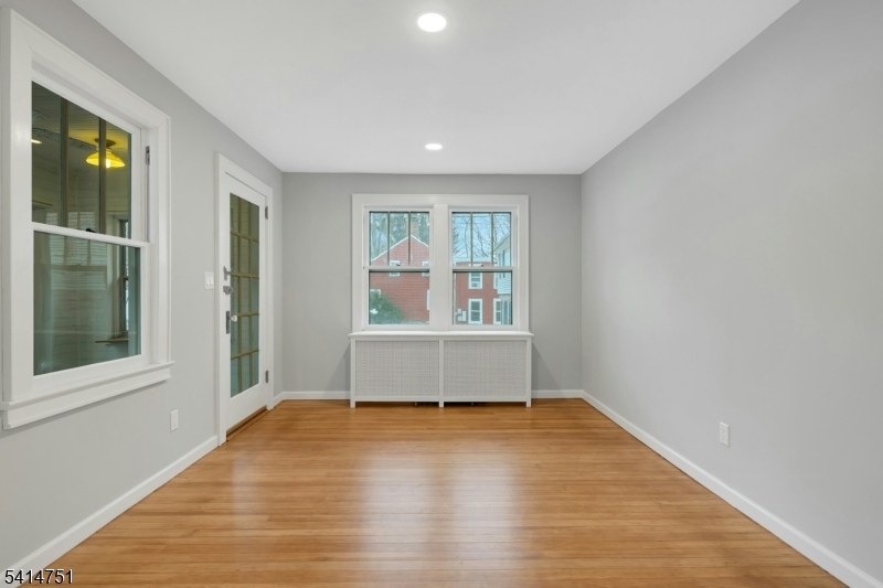 173 Runnymede Road West Caldwell, NJ 07006 - Photo 9 of 27 an empty room with wooden floor and windows