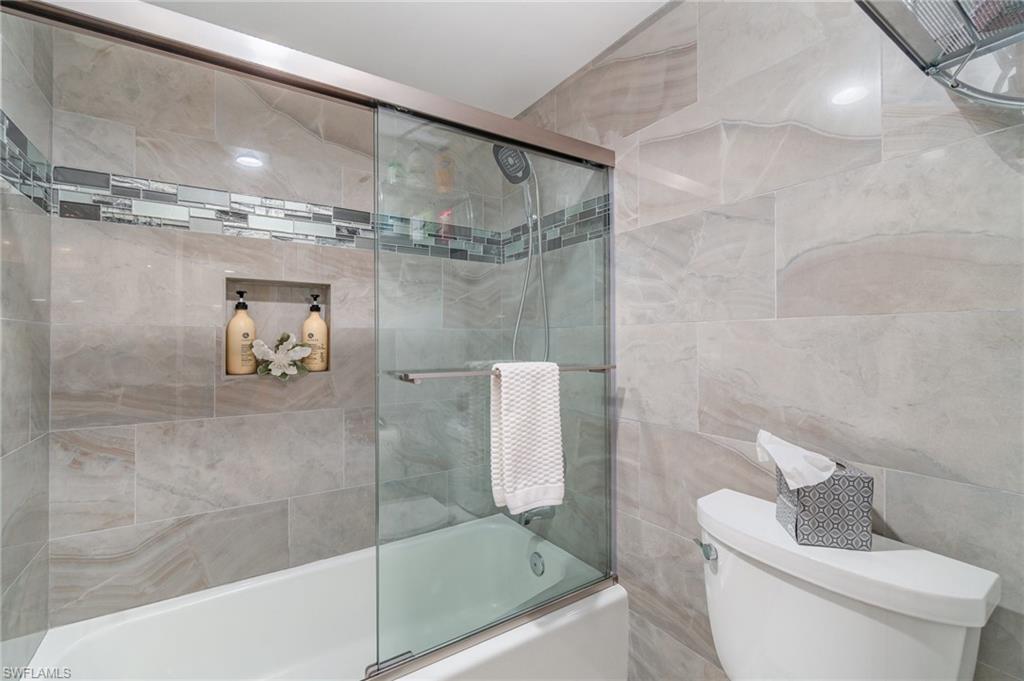25806 Cockleshell Drive, Unit 115 Bonita Springs, FL 34135 - Photo 15 of 25 a bathroom with a shower and toilet