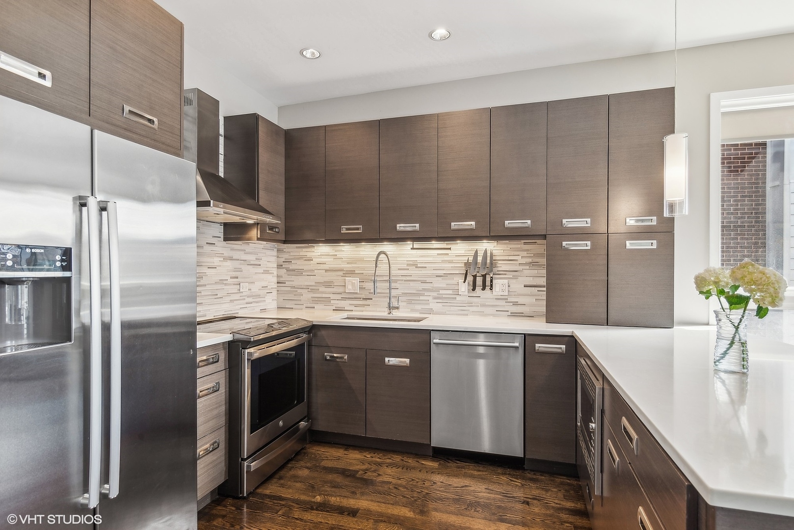 2136 West North Avenue, Unit 2E Chicago, IL 60647 - Photo 10 of 22 a kitchen with stainless steel appliances granite countertop a sink stove and refrigerator