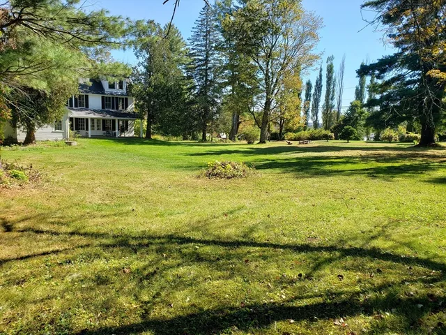 a view of swimming pool with outdoor seating and trees