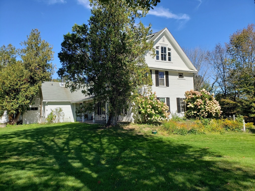 1 Searle Road Huntington, MA 01050 - Photo 3 of 42 a front view of a house with a garden