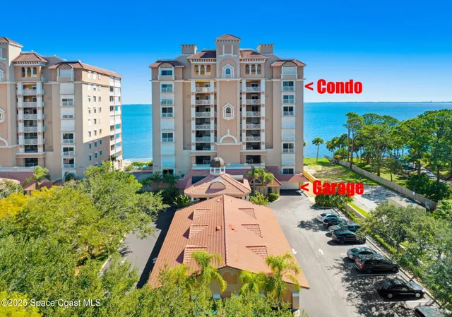 a front view of multi story residential apartment building with yard and sign board