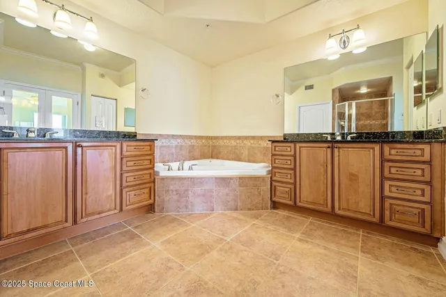 a spacious bathroom with a granite countertop tub sink and mirror
