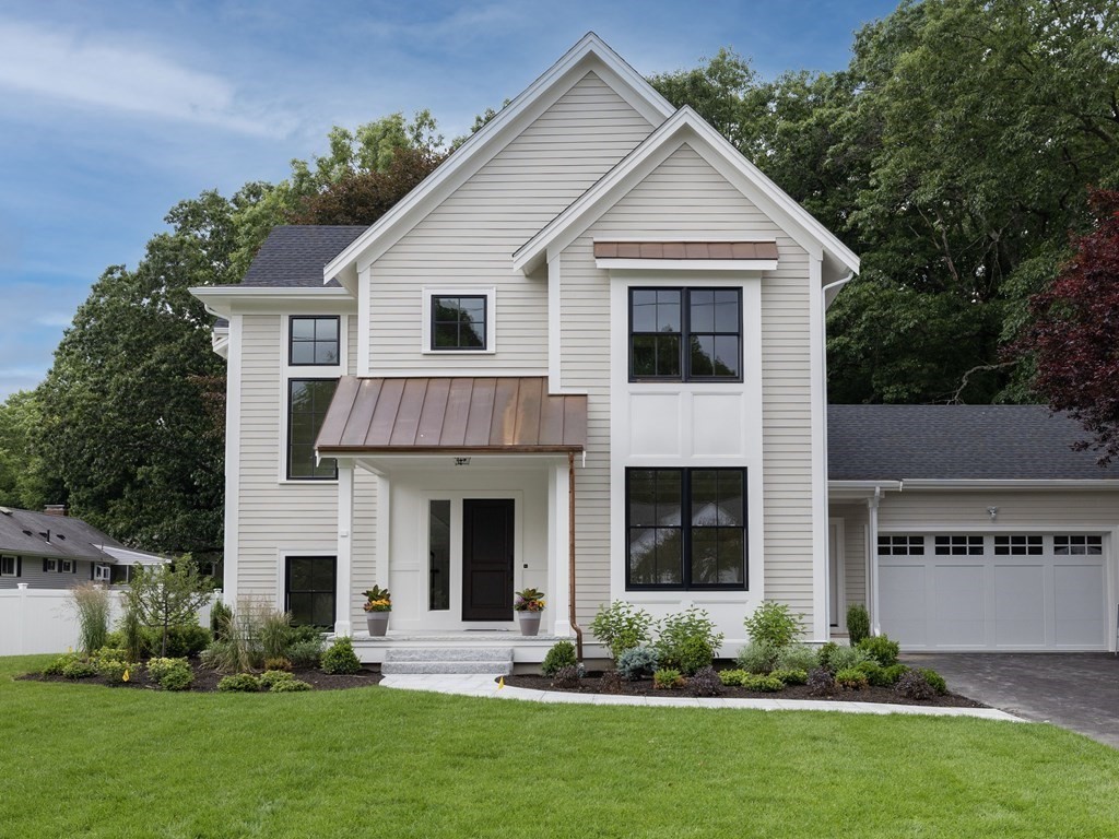 23 Bobolink Road Wellesley, MA 02481 - Photo 1 of 1 a front view of a house with a yard and garage