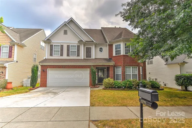 a front view of a house with swimming pool and glass windows