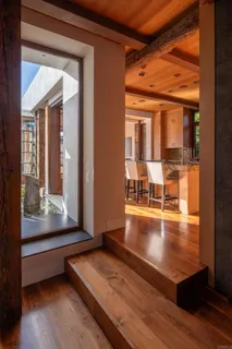 a living room with furniture and a floor to ceiling window