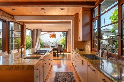a living room with furniture a rug and a floor to ceiling window