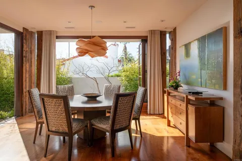 a living room with furniture and a floor to ceiling window