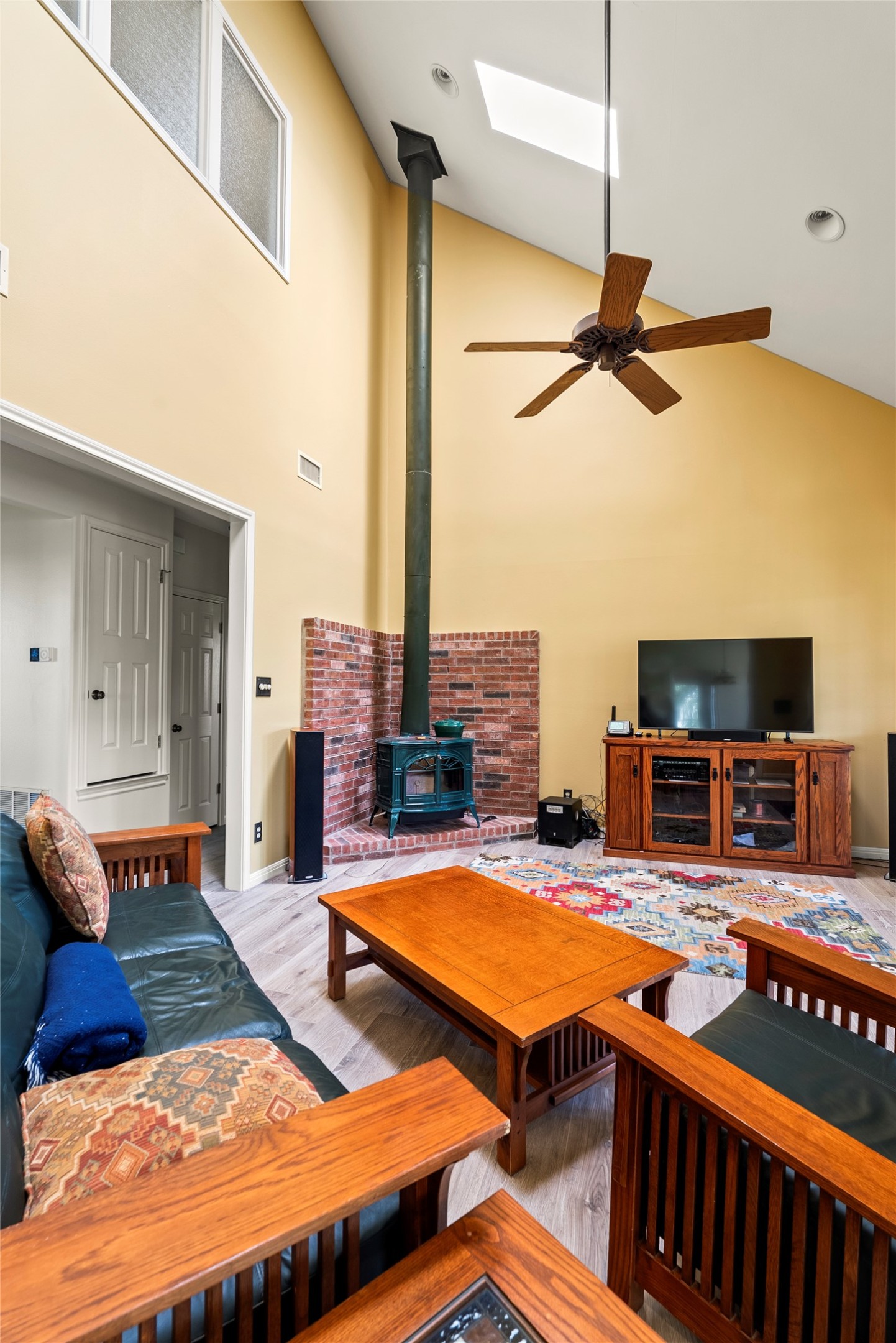 928 Upper Elgin River Road Elgin, TX 78621 - Photo 11 of 40 Vaulted ceiling with skylight and wood-finish flooring.