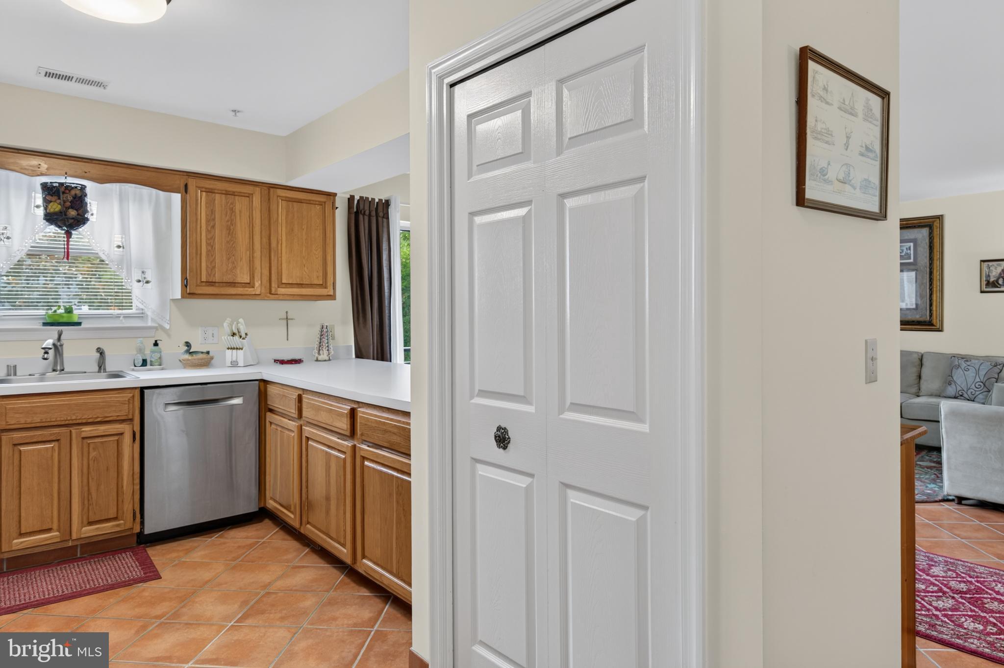936 Bay Ridge Avenue, Unit 201 Annapolis, MD 21403 - Photo 28 of 40 a kitchen with stainless steel appliances granite countertop white cabinets and window