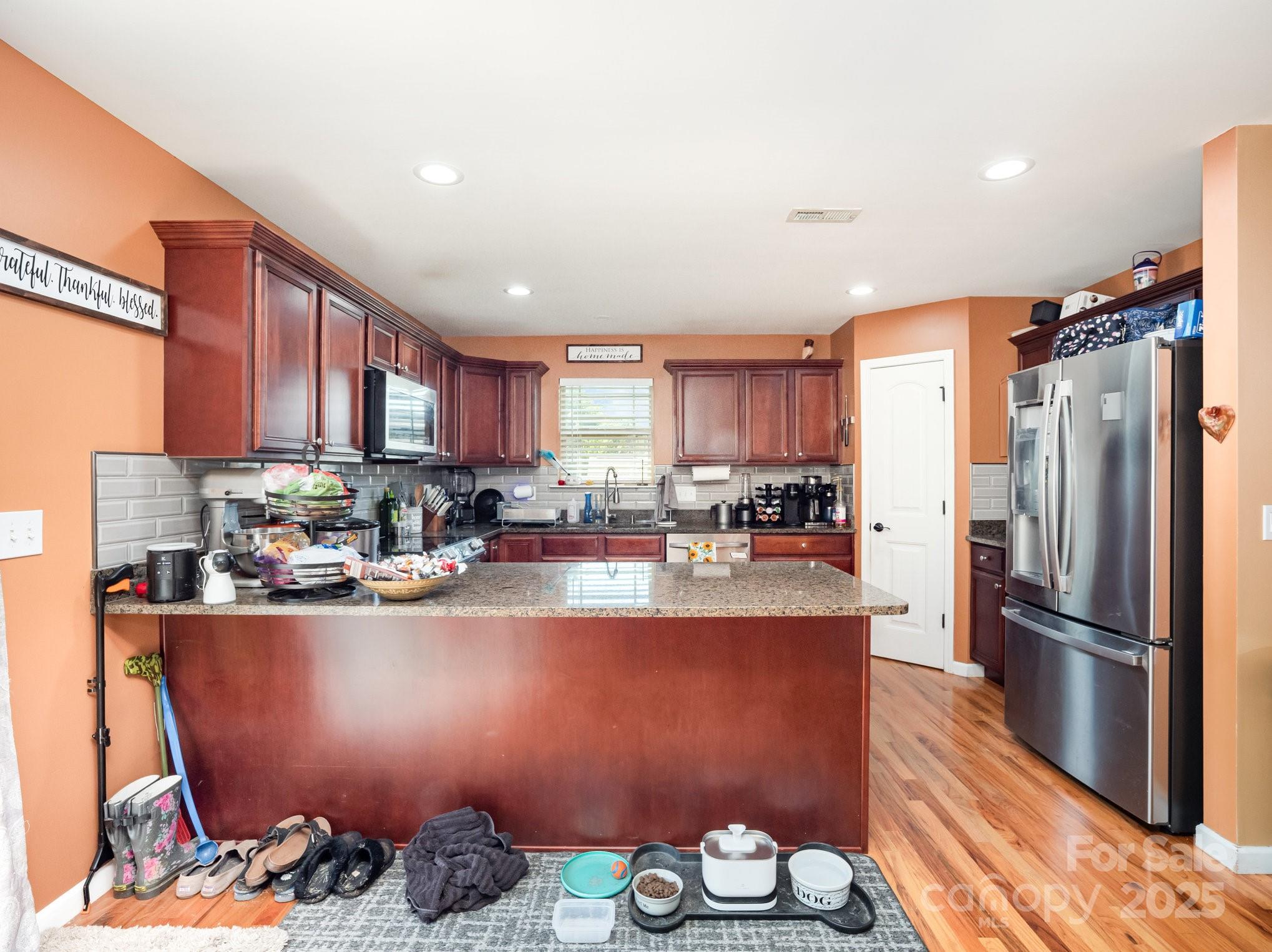 190 Glendower Lane Chesnee, SC 29323 - Photo 12 of 29 a kitchen with stainless steel appliances granite countertop a refrigerator a stove and a sink with wooden floor