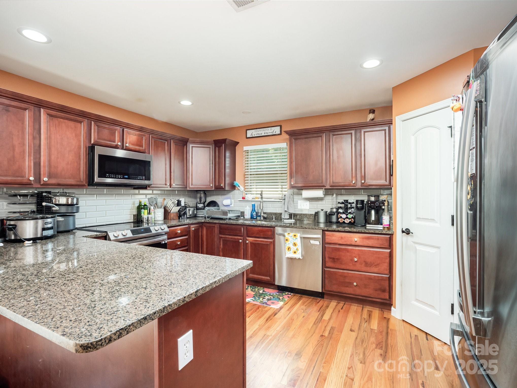 190 Glendower Lane Chesnee, SC 29323 - Photo 13 of 29 a kitchen with stainless steel appliances granite countertop wooden cabinets a stove top oven a sink and dishwasher