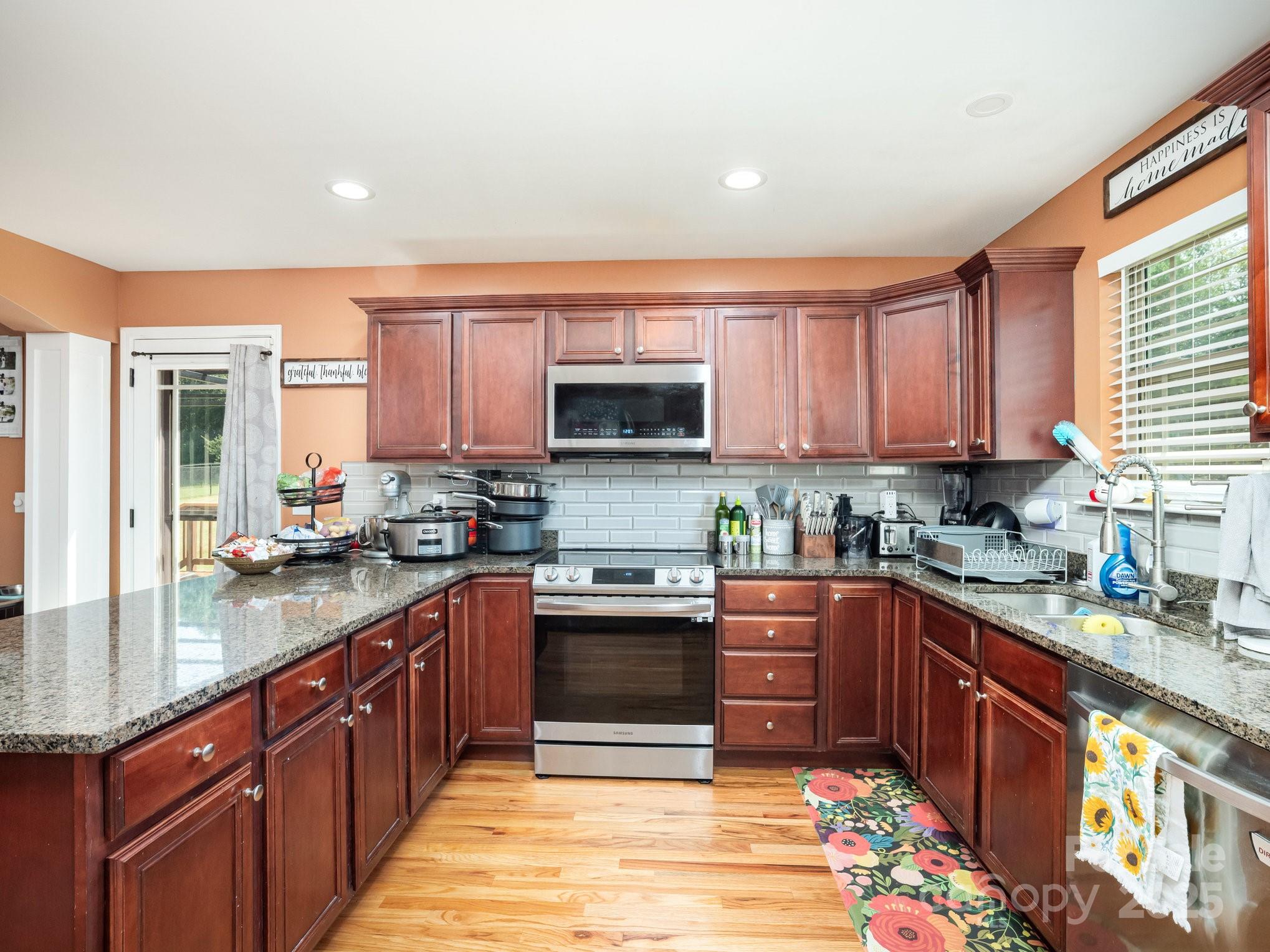 190 Glendower Lane Chesnee, SC 29323 - Photo 14 of 29 a kitchen with stainless steel appliances granite countertop a stove sink microwave and cabinets