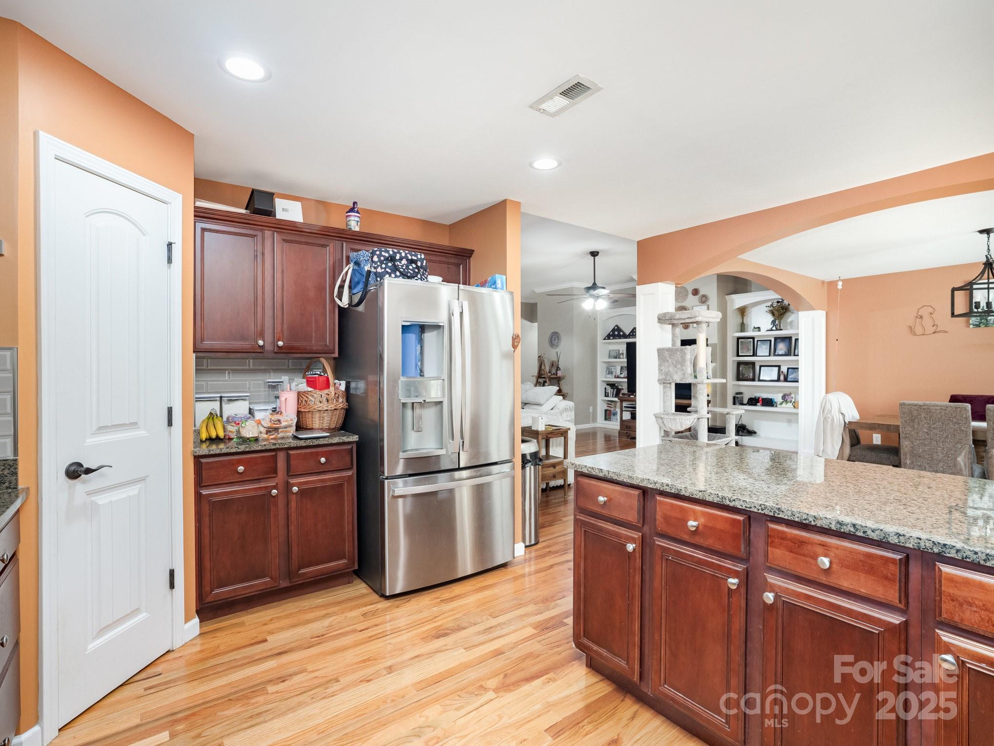 190 Glendower Lane Chesnee, SC 29323 - Photo 15 of 29 a kitchen with granite countertop a refrigerator and wooden cabinets