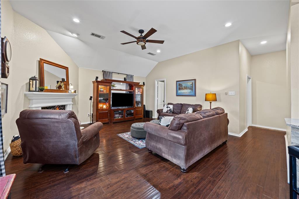 112 Springfield Lane Red Oak, TX 75165 - Photo 12 of 40 a living room with furniture a flat screen tv and a fireplace
