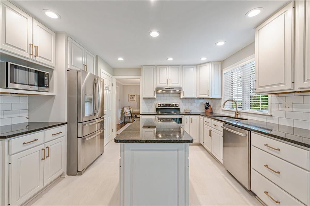 103 Lexington Drive Canonsburg, PA 15317 - Photo 21 of 44 a kitchen with white cabinets and stainless steel appliances