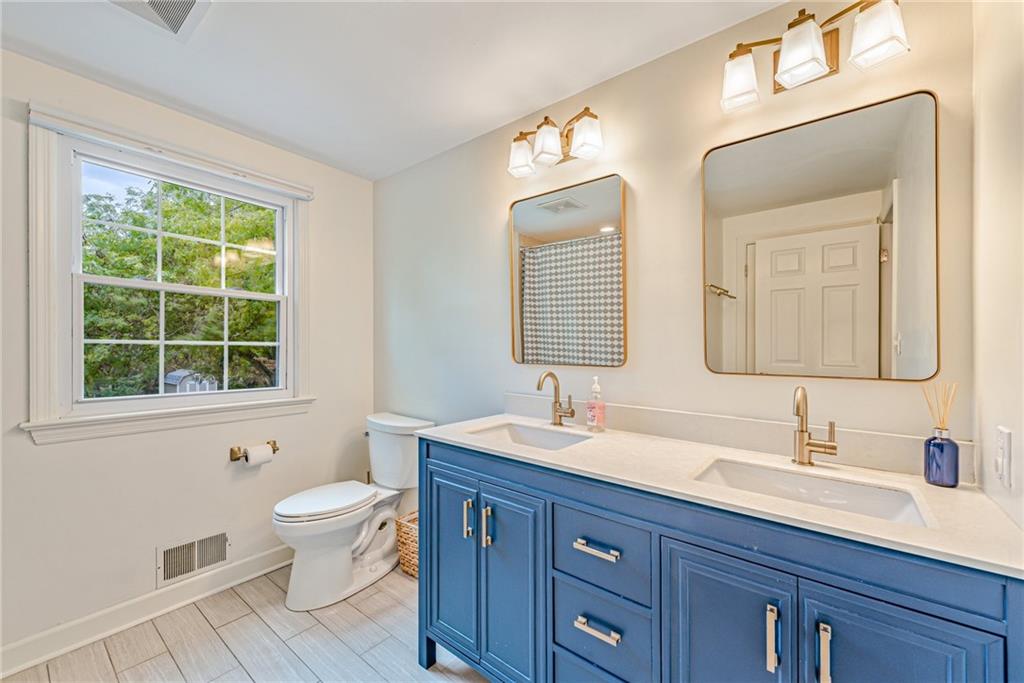 103 Lexington Drive Canonsburg, PA 15317 - Photo 28 of 44 a bathroom with a double vanity sink a toilet and a mirror
