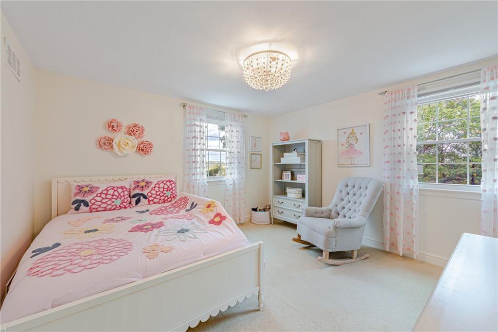 103 Lexington Drive Canonsburg, PA 15317 - Photo 29 of 44 a bedroom with a bed and a chandelier