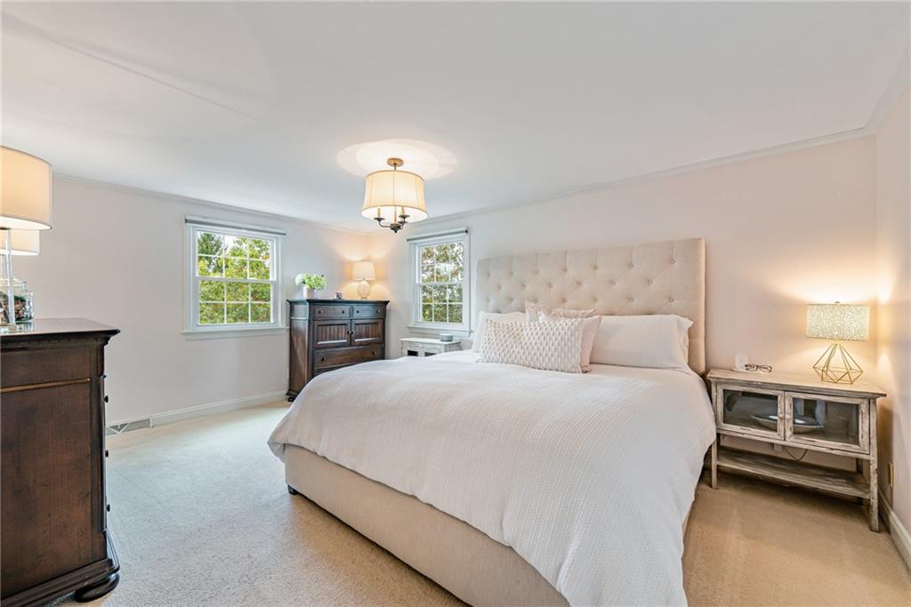 103 Lexington Drive Canonsburg, PA 15317 - Photo 31 of 44 a bedroom with a large bed and a chandelier