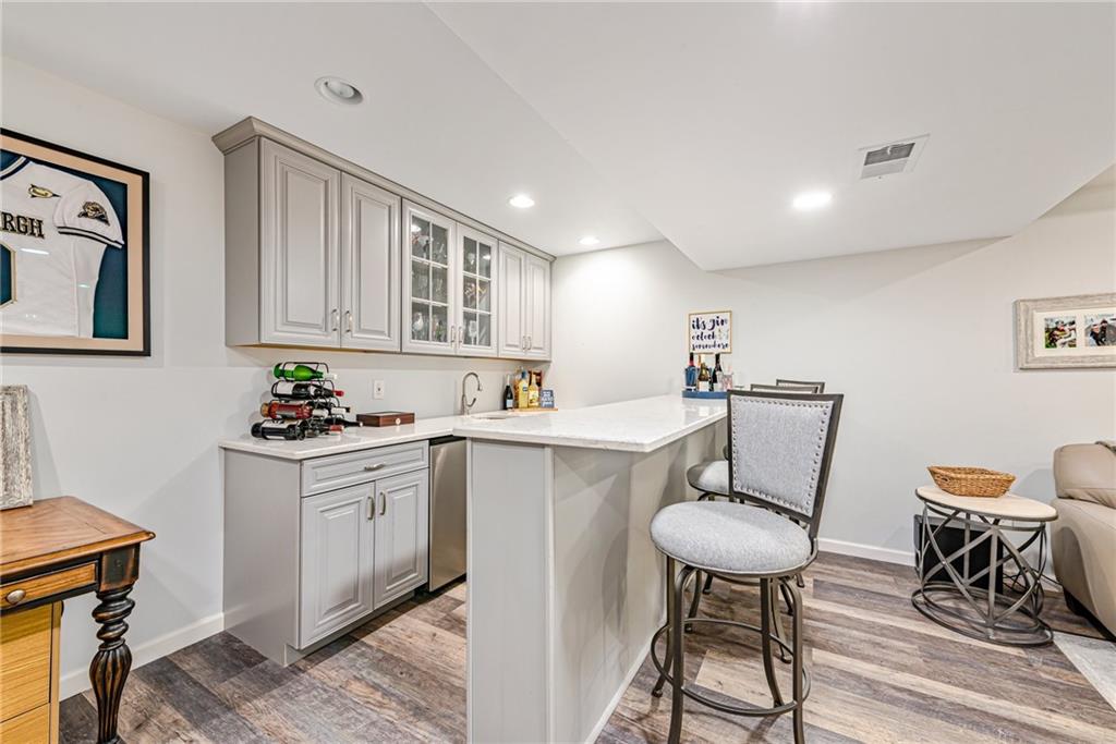 103 Lexington Drive Canonsburg, PA 15317 - Photo 35 of 44 a kitchen with a table chairs sink and cabinets