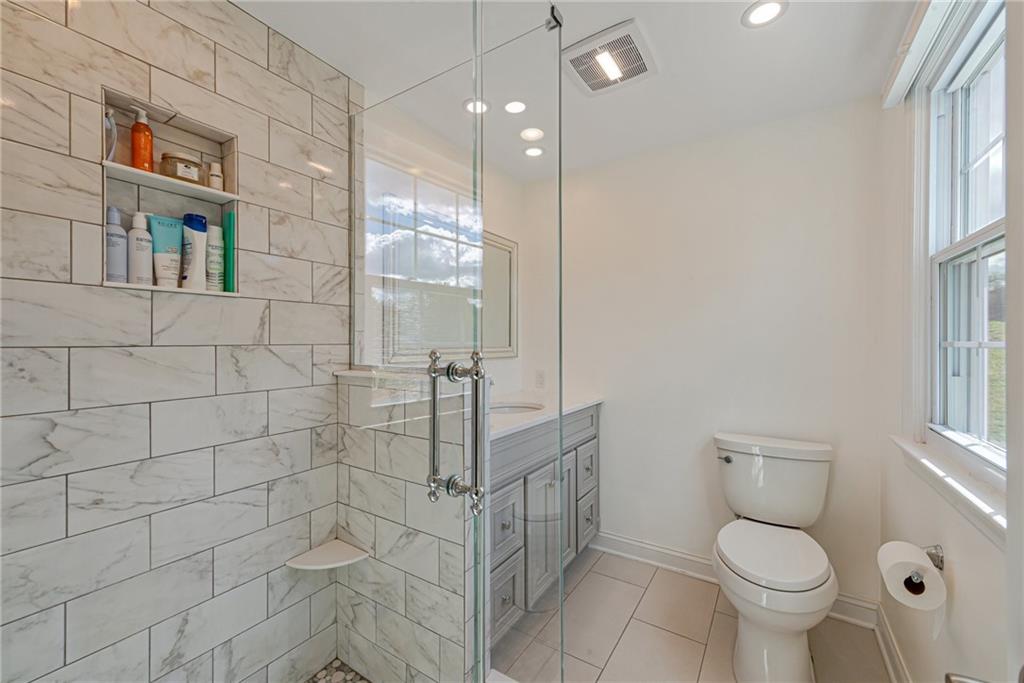 103 Lexington Drive Canonsburg, PA 15317 - Photo 4 of 44 a bathroom with a toilet a sink and mirror