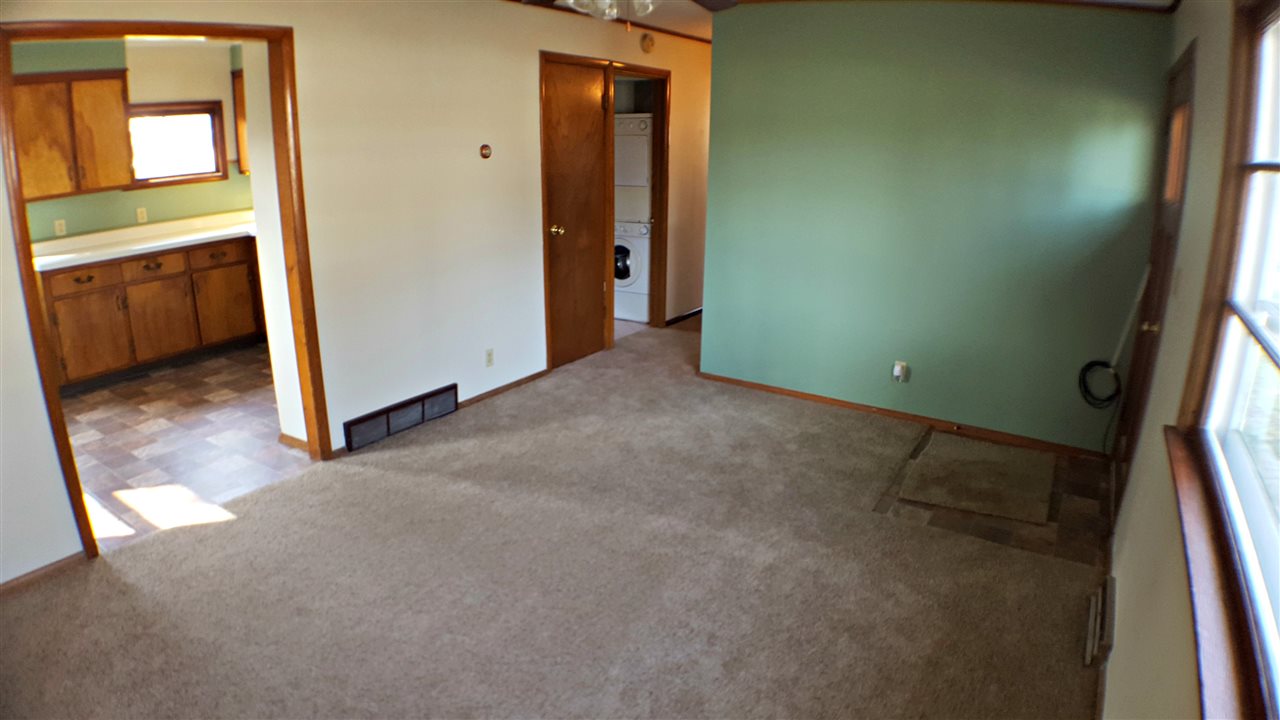 7608 Randy Road Machesney Park, IL 61115 - Photo 3 of 20 an empty room with windows and cabinet