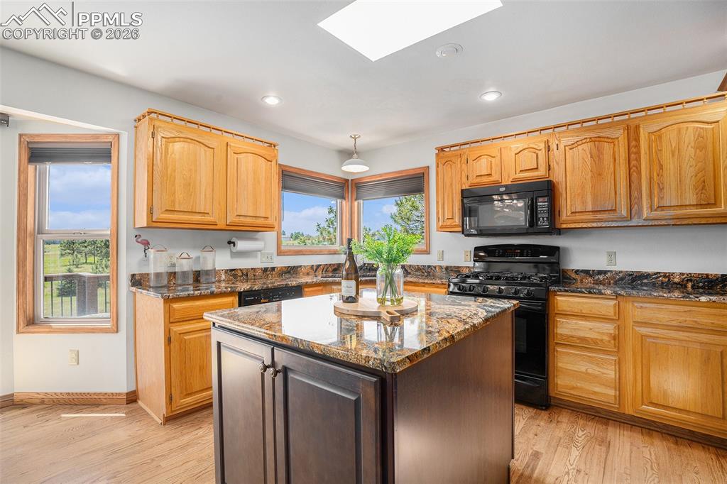 2585 Mohawk Way Monument, CO 80132 - Photo 11 of 49 a kitchen with a sink stove top oven and microwave