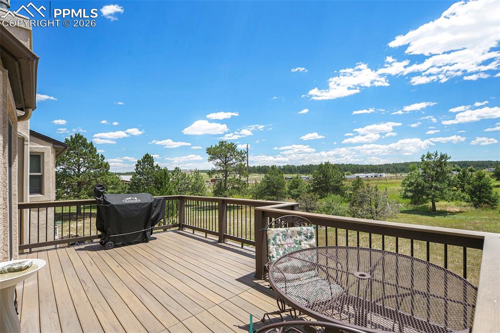 2585 Mohawk Way Monument, CO 80132 - Photo 18 of 49 a view of a balcony with wooden floor and iron fence