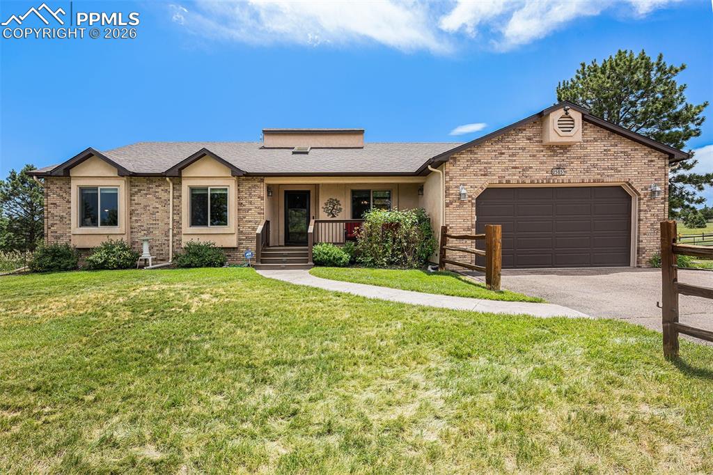 2585 Mohawk Way Monument, CO 80132 - Photo 2 of 49 a front view of a house with garden