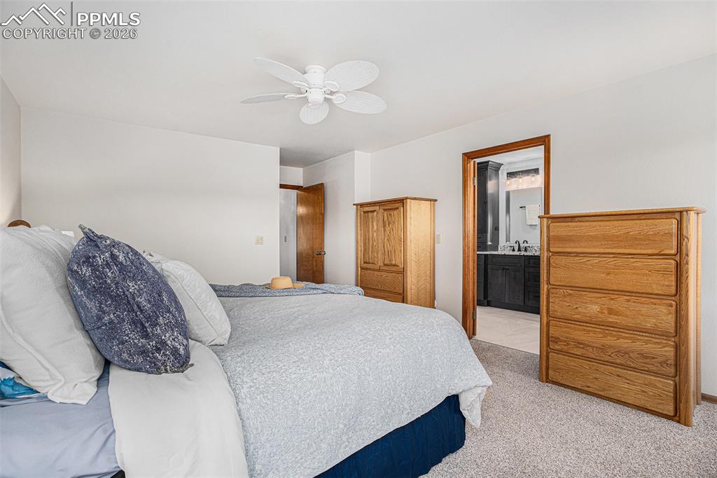 2585 Mohawk Way Monument, CO 80132 - Photo 21 of 49 a spacious bedroom with a bed and cabinet