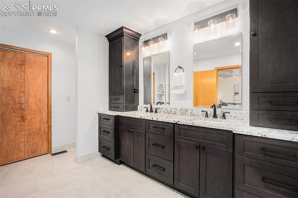 2585 Mohawk Way Monument, CO 80132 - Photo 23 of 49 a bathroom with a granite countertop sink mirror and double