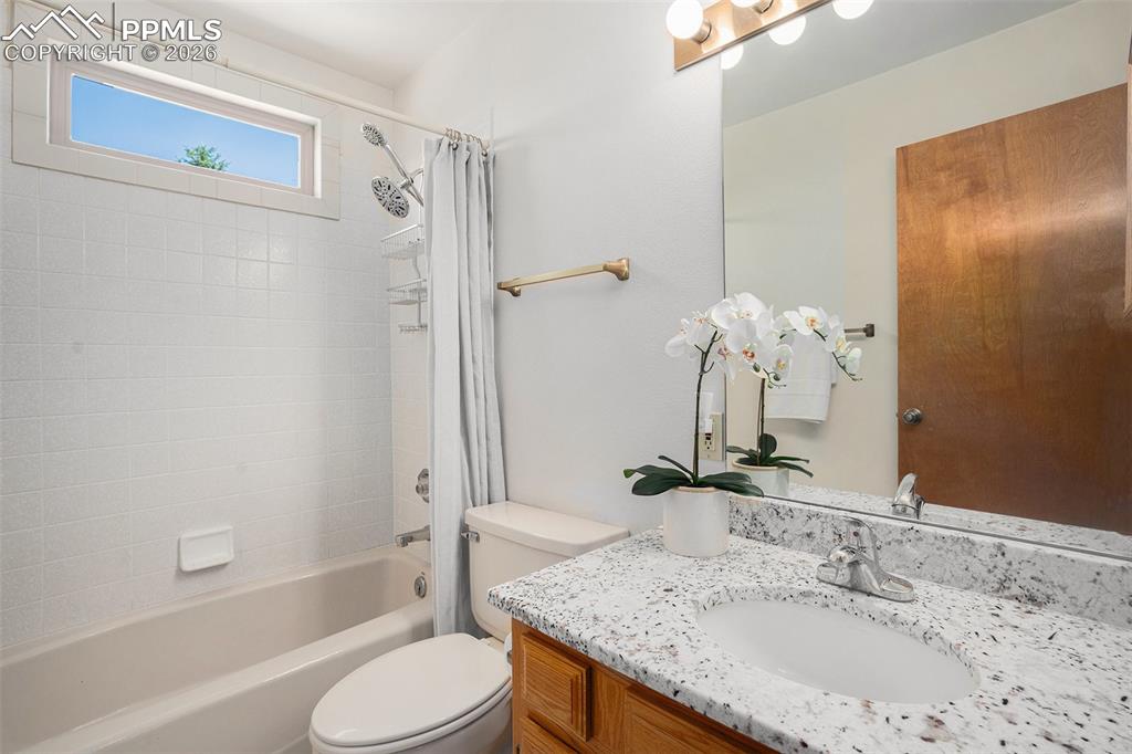 2585 Mohawk Way Monument, CO 80132 - Photo 25 of 49 a bathroom with a granite countertop sink toilet and shower