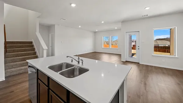 a kitchen with a sink a microwave a stove and refrigerator