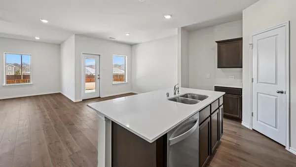 a kitchen with stainless steel appliances a sink a stove and a microwave