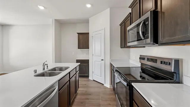 a stove top oven sitting inside of a kitchen