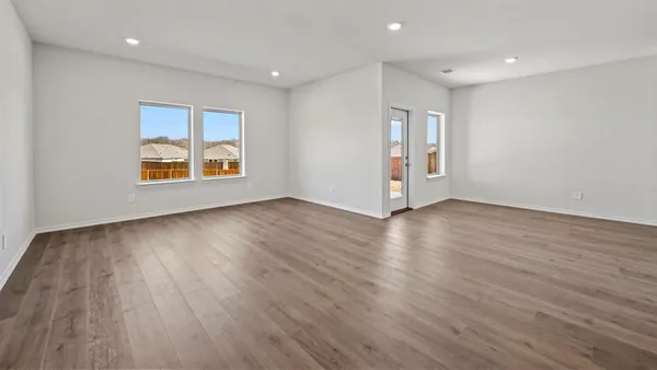 a view of a kitchen with a sink and wooden floor